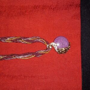 Braided necklace with flashy pendant